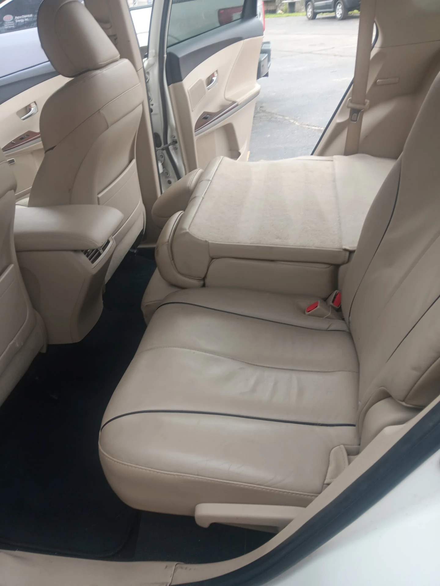 Freshly detailed light leather rear seats and clean black carpeting